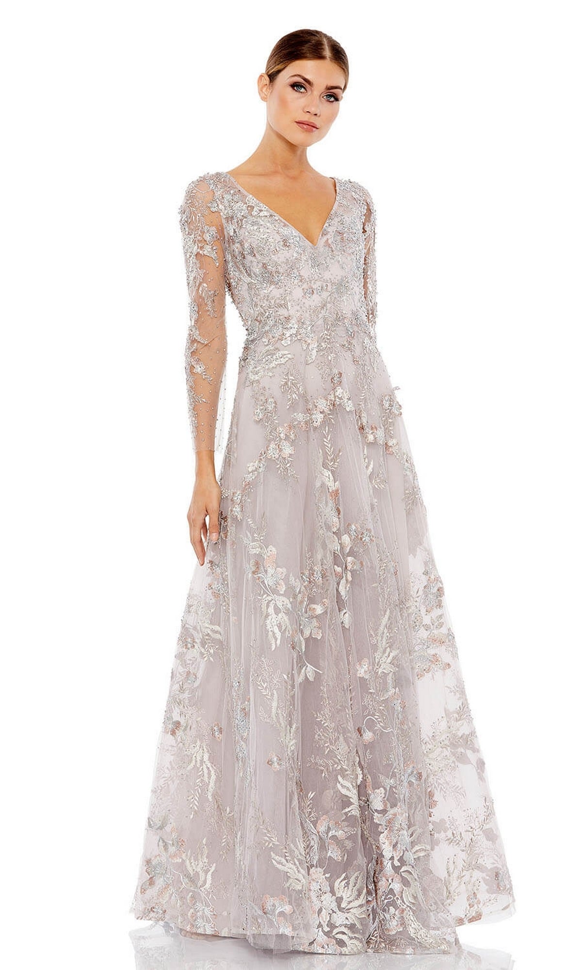 Woman wearing the Mac Duggal 20245 Long Violet Lace Formal Dress with floral embroidery, sheer long sleeves, and a V-neck, standing against a plain white background.